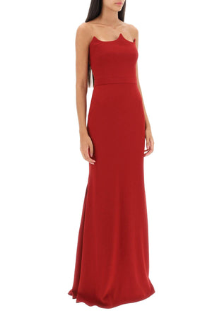 赤いマーメイドシルエットの夜のドレス。ボーンドコルセットとピーカブーネックライン付き。