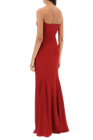 赤いマーメイドシルエットの夜のドレス。ボーンドコルセットとピーカブーネックライン付き。